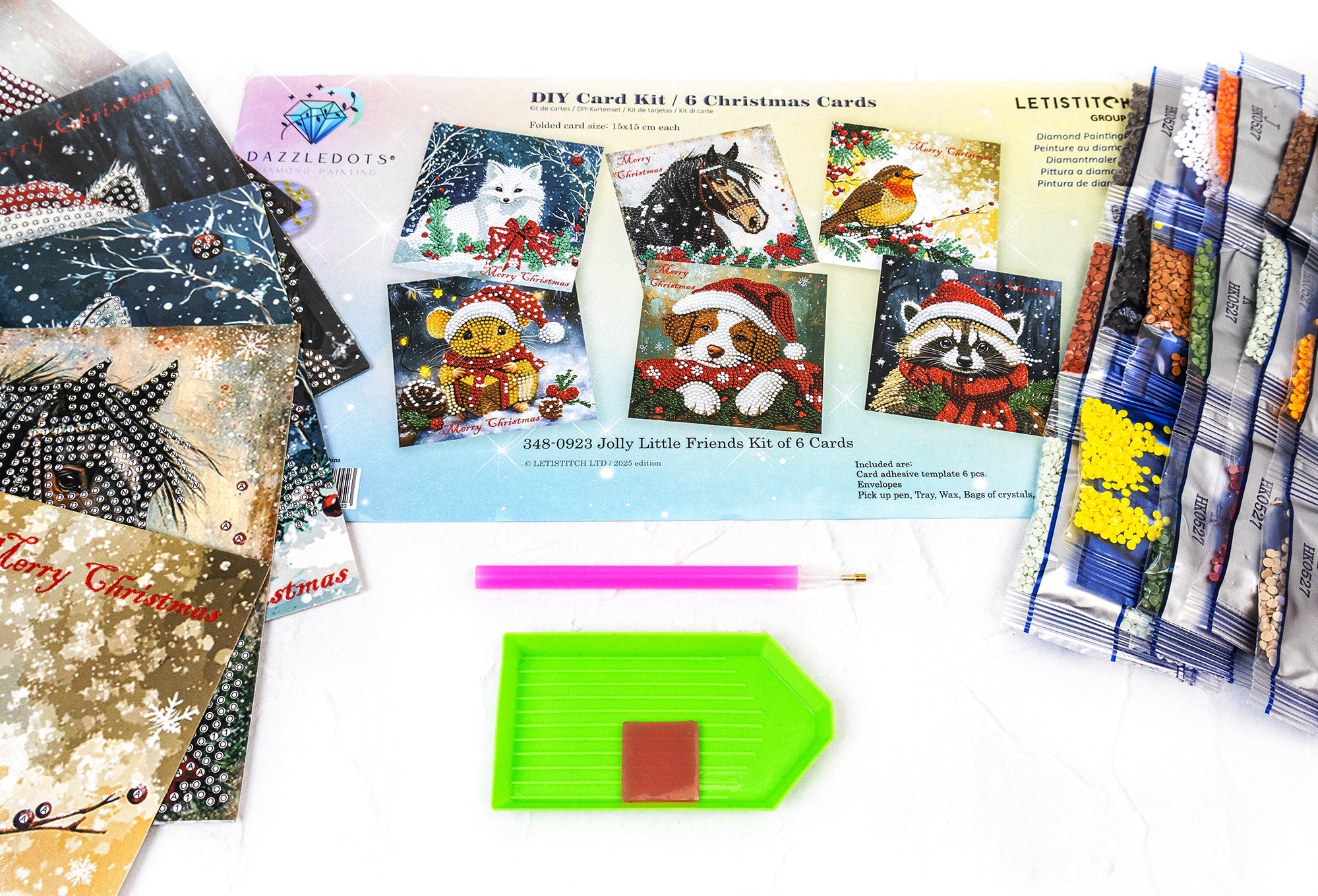 Collection of Christmas-themed cards and craft materials on a white surface