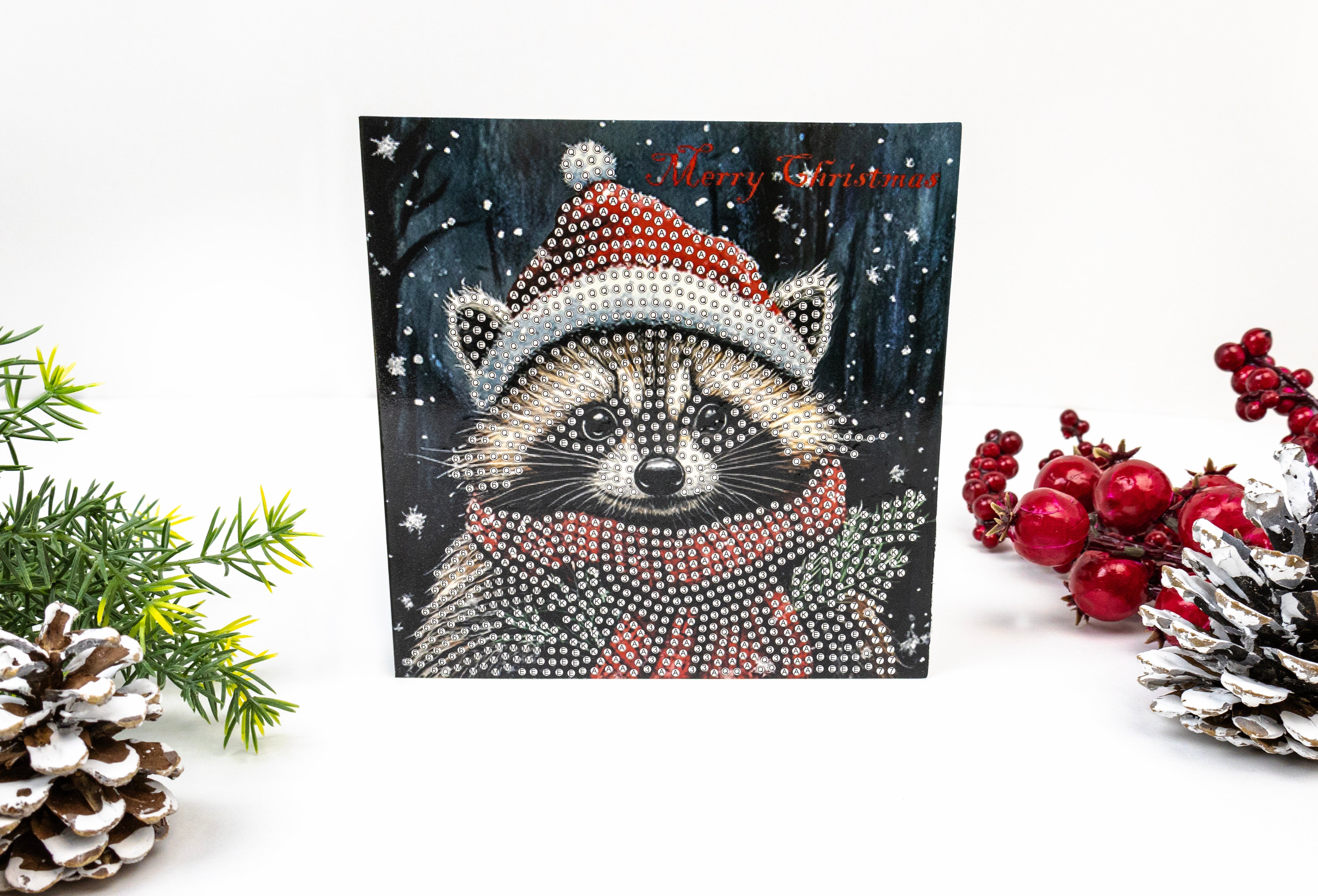 Christmas card with a raccoon wearing a Santa hat, surrounded by festive decorations on a white background.