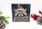 Christmas card with a raccoon wearing a Santa hat, surrounded by festive decorations on a white background.