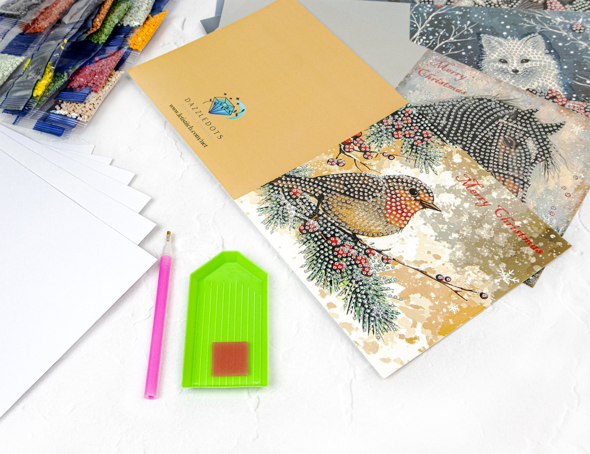 Holiday greeting cards with winter-themed designs on a white surface.