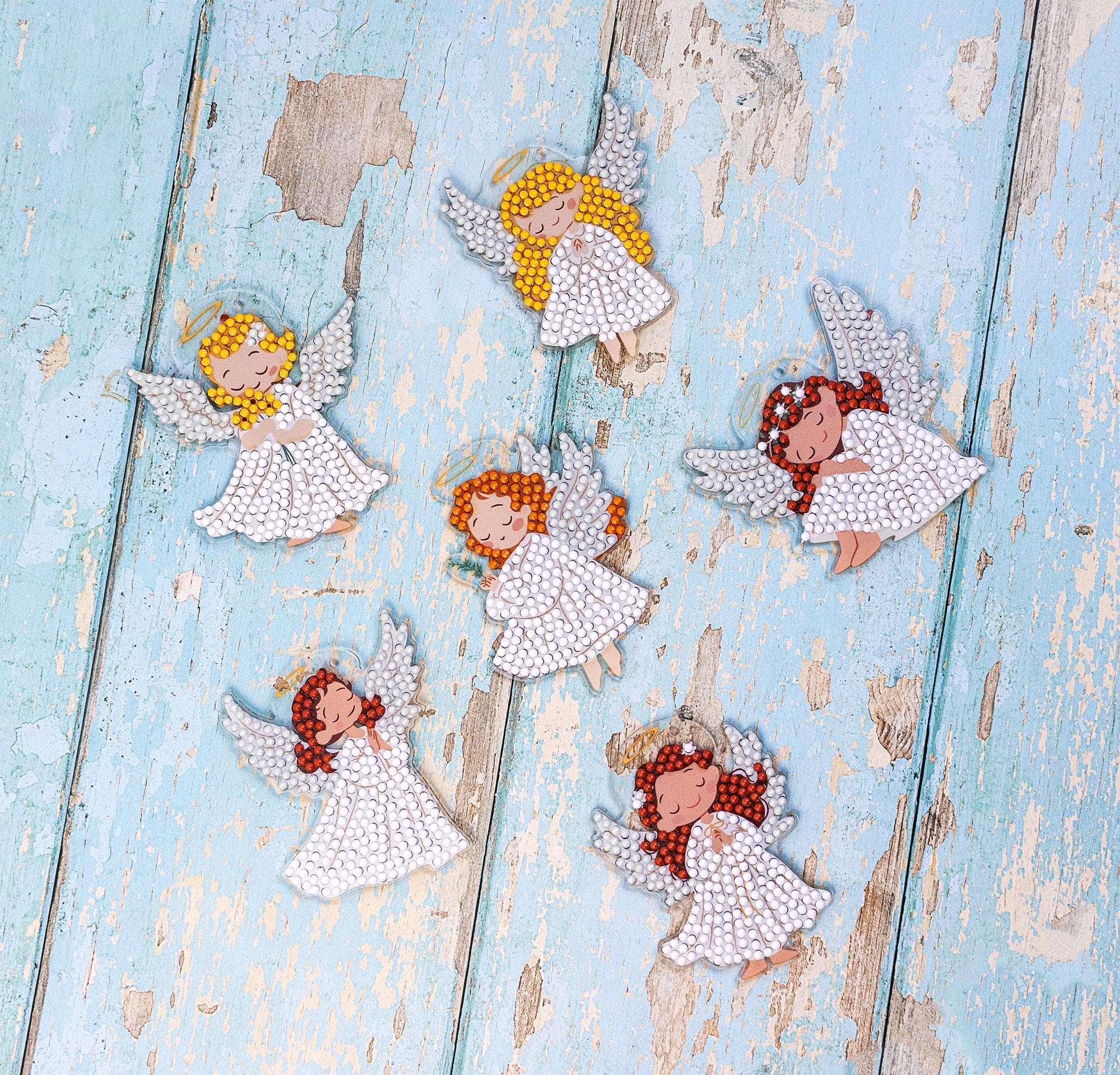 Decorative angel figurines on a textured blue surface