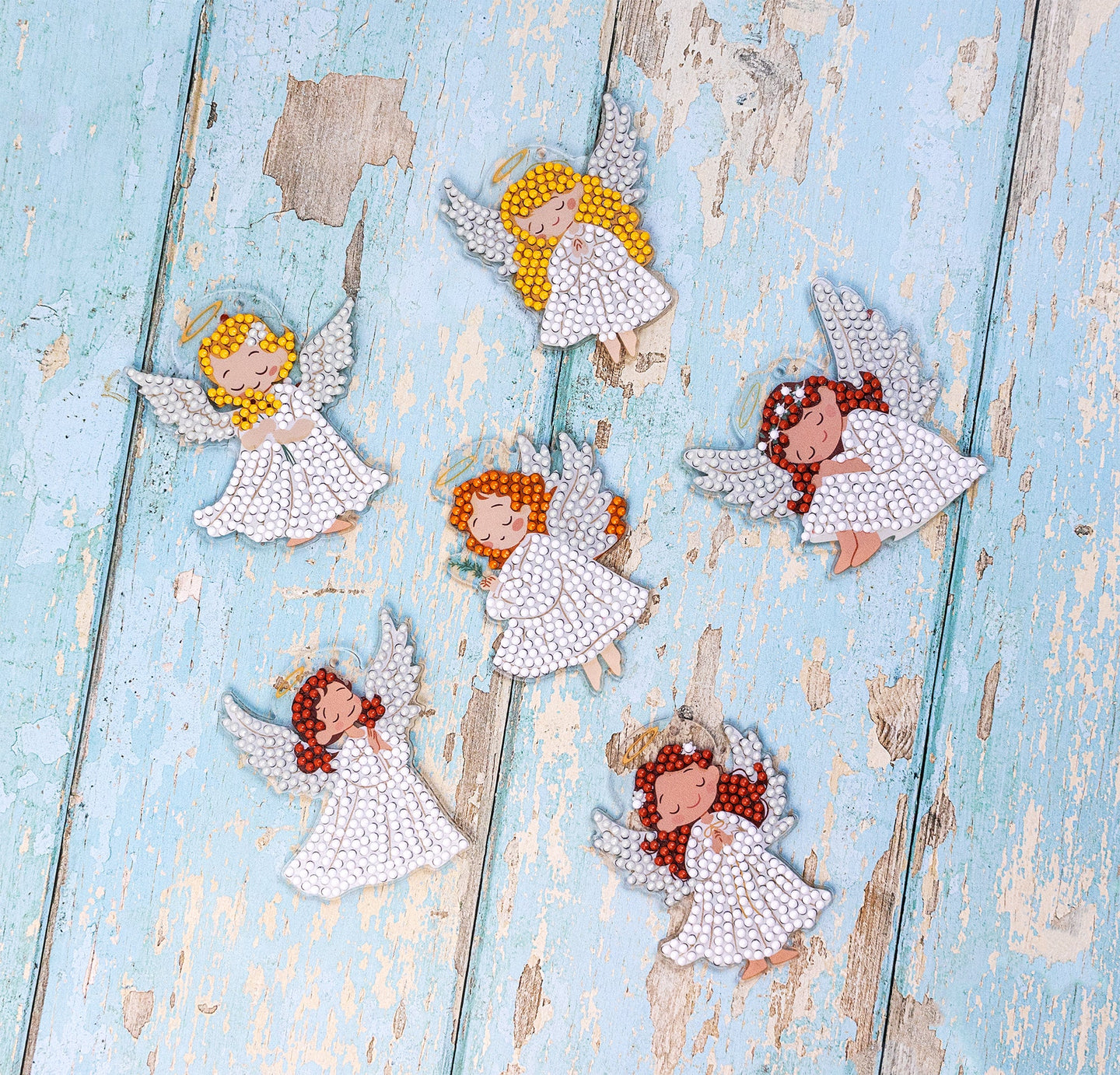 Decorative angel figurines on a textured blue surface