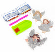 Decorative angel figurines with craft supplies on a white background