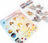 Hanging charm kit with angel designs and gold chain on a white background