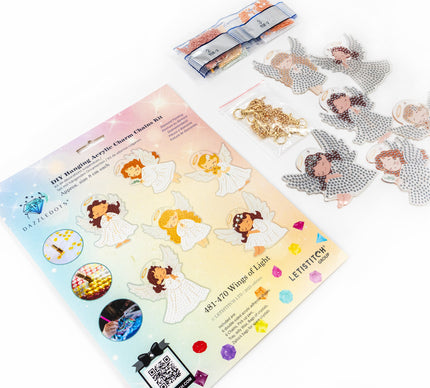 Hanging charm kit with angel designs and gold chain on a white background