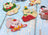 Decorative Christmas-themed cat figurines made with beads on a wooden surface.