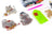 Decorative cat designs made with beads on a white surface with craft supplies.
