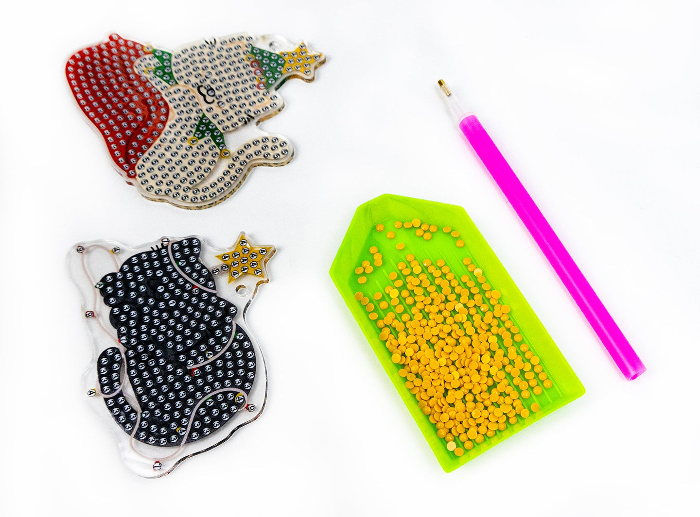 Decorative items including a beaded glove, a beading tool, and beads on a white background