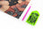 card with Artistic depiction of a black cat with flowers, pink pencil, and green crystals tray on a white background