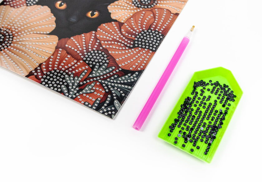 card with Artistic depiction of a black cat with flowers, pink pencil, and green crystals tray on a white background