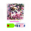 Christmas-themed card with a puppy in a gift, surrounded by ribbons and ornaments, with stationery items at the bottom.