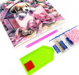 Crafting kit with diamond painting canvas, tools, and beads on a white background