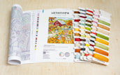 Letistitch embroidery kit with pattern book and thread set on a wooden surface