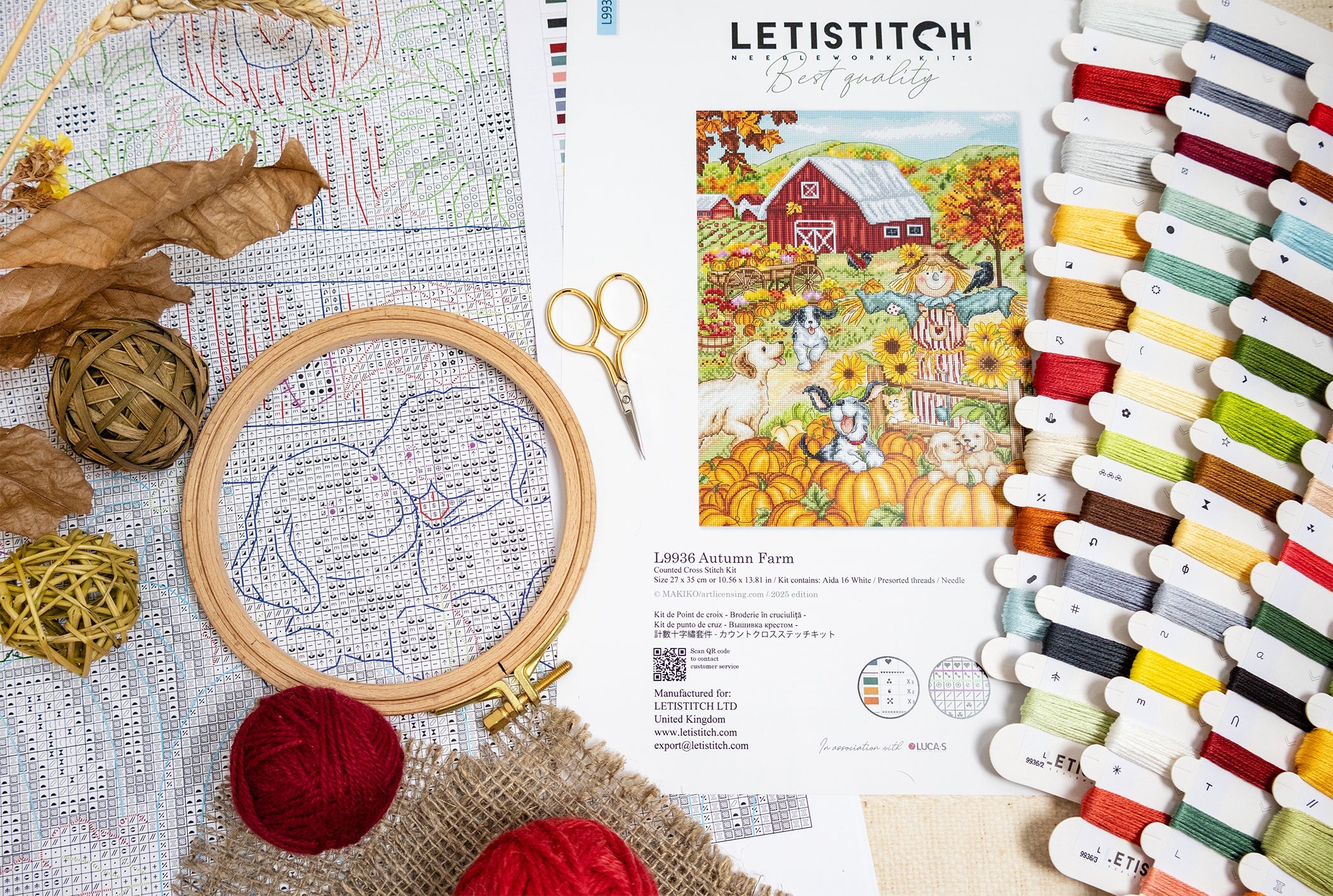 Embroidery hoop, threads, scissors, and a pattern book on a table with a Letistitch brand label.