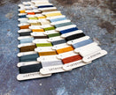Color swatch card with various yarn colors on a textured surface