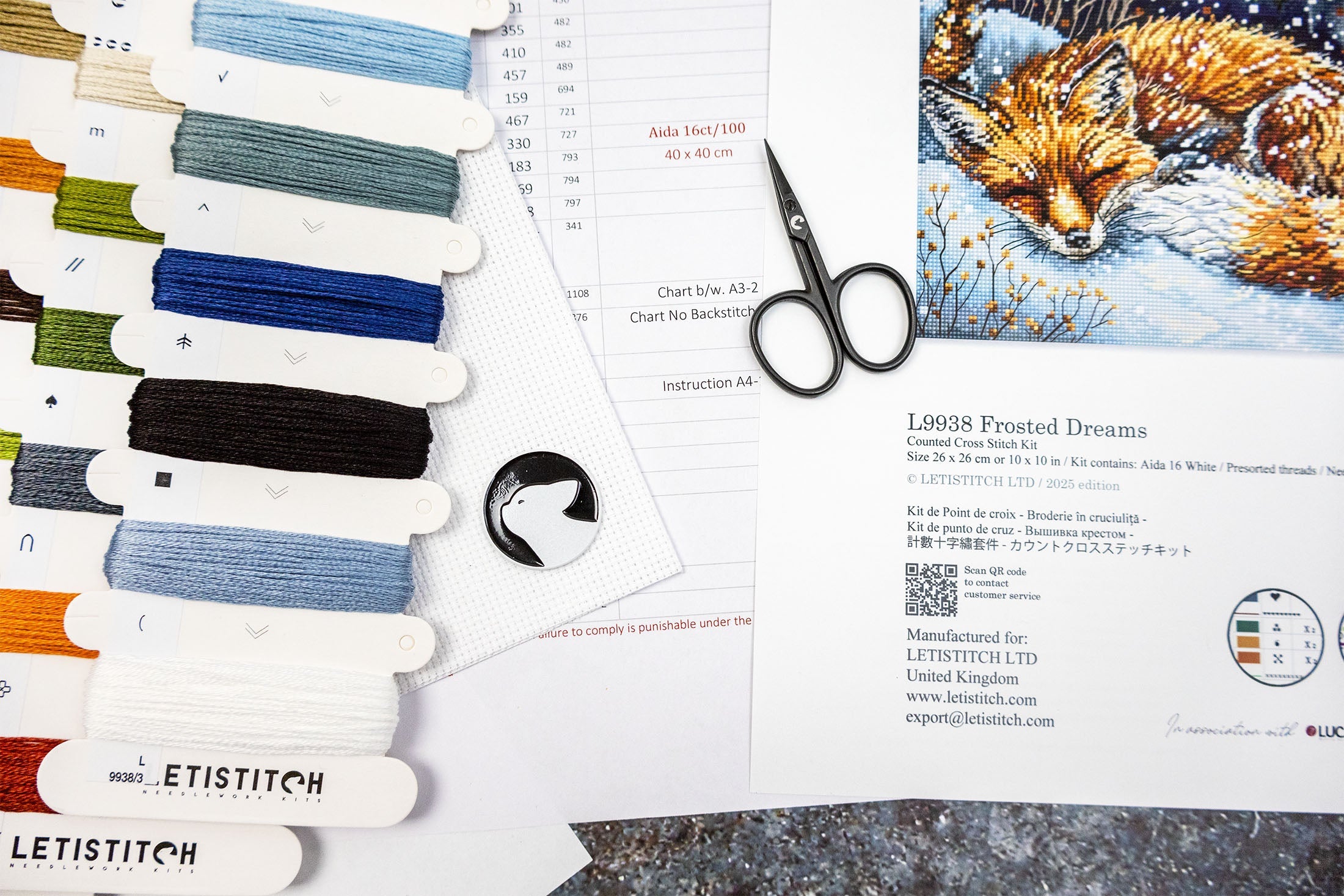 Embroidery thread set with scissors and a sleeping fox illustration on a white background