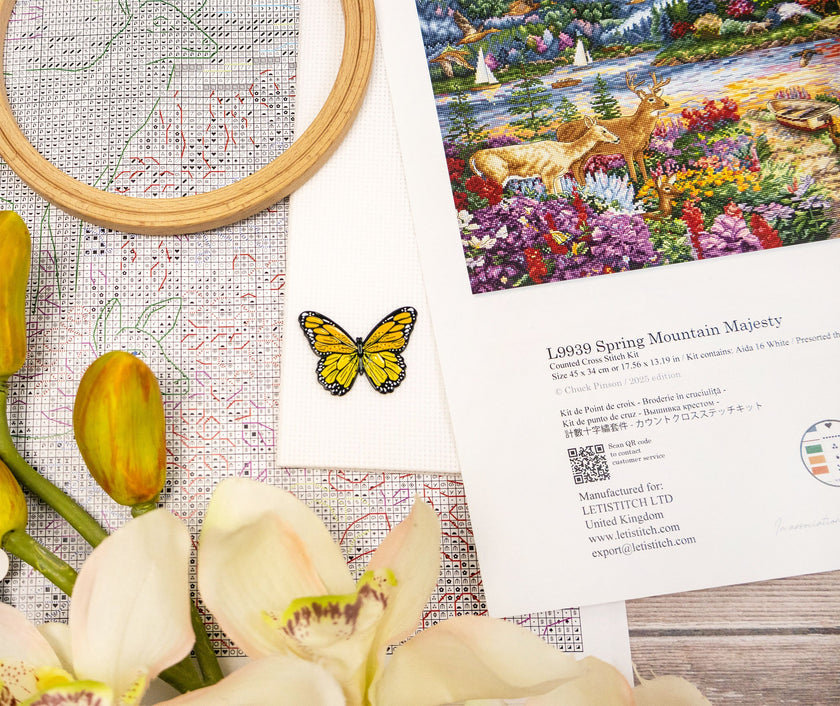 Cross-stitch kit with a deer and floral design, surrounded by flowers and a butterfly.