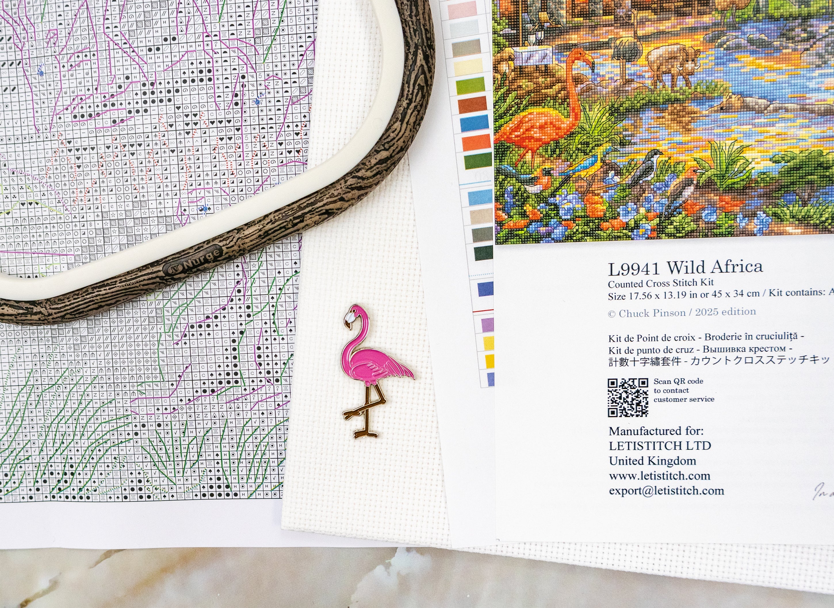 Embroidery kit with flamingo design and color swatch on a white surface
