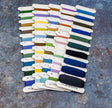 Color swatch card with embroidery floss on a textured surface