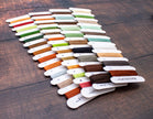 Set of colorful thread samples on a wooden surface