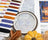Cross-stitch kit with embroidery hoop, threads, and Halloween-themed fabric