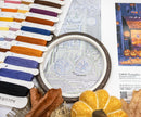 Cross-stitch kit with embroidery hoop, threads, and Halloween-themed fabric