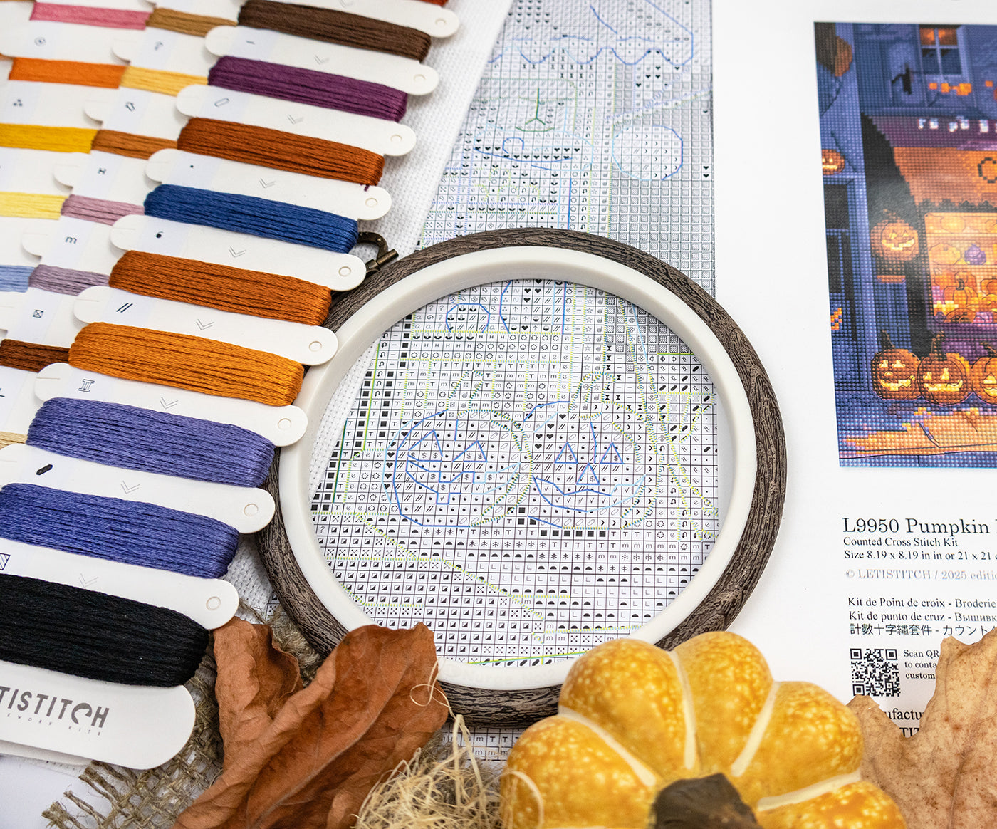 Cross-stitch kit with embroidery hoop, threads, and Halloween-themed fabric