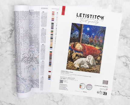 Letistitch embroidery kit with design chart and image of baby Jesus on a marble surface