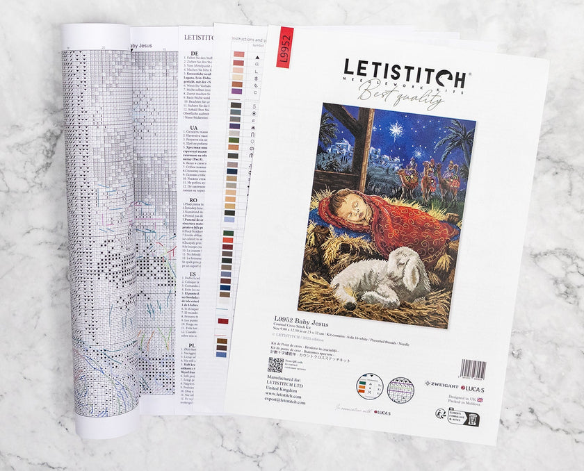 Letistitch embroidery kit with design chart and image of baby Jesus on a marble surface