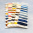 Set of embroidery threads on wooden sticks with 'Letistitch' branding on a light gray background