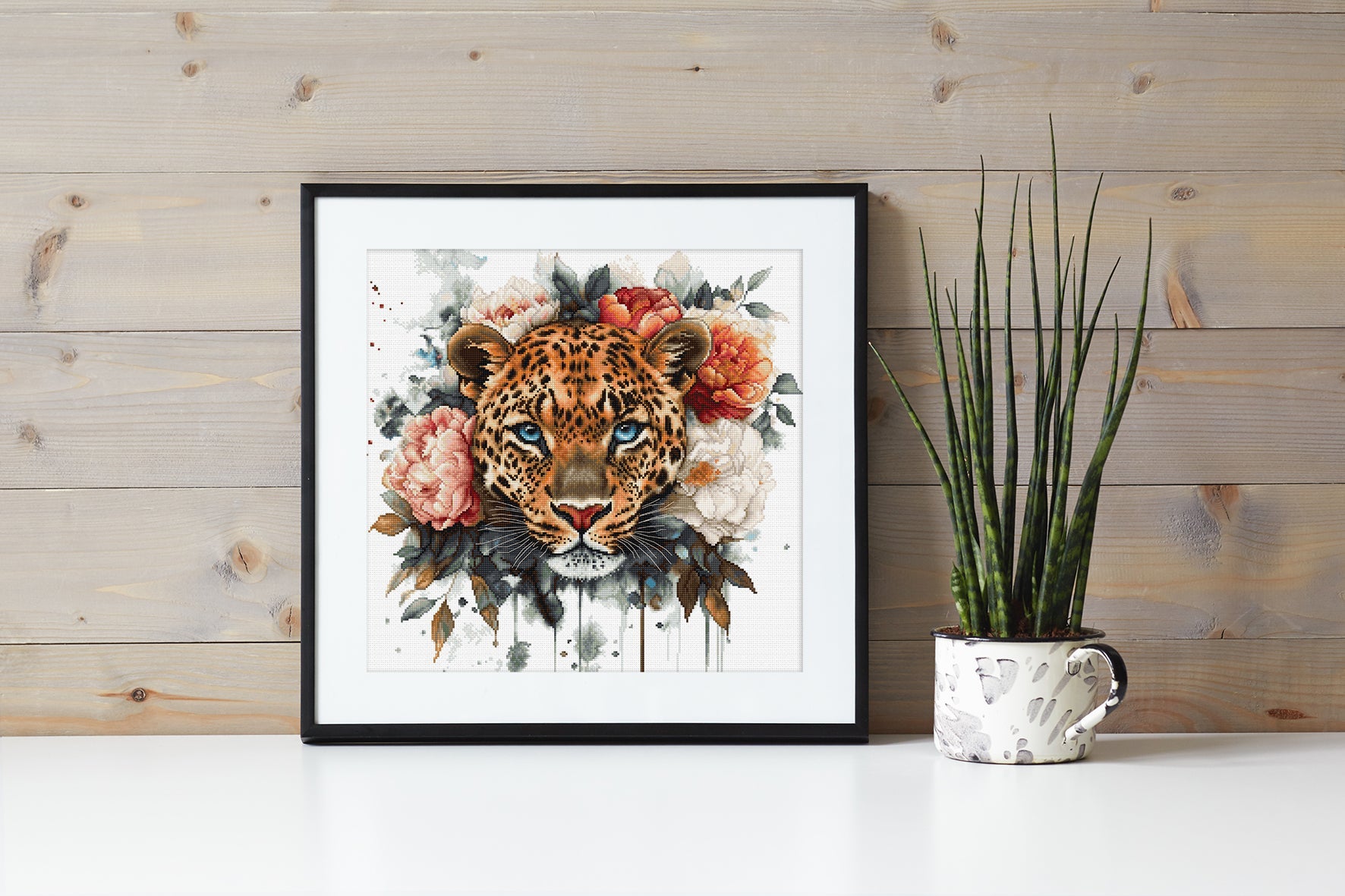 Framed artwork of a leopard with flowers on a wooden wall.