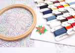 Embroidery hoop with cross-stitch pattern, color swatch, and Letistitch branding on a white surface.