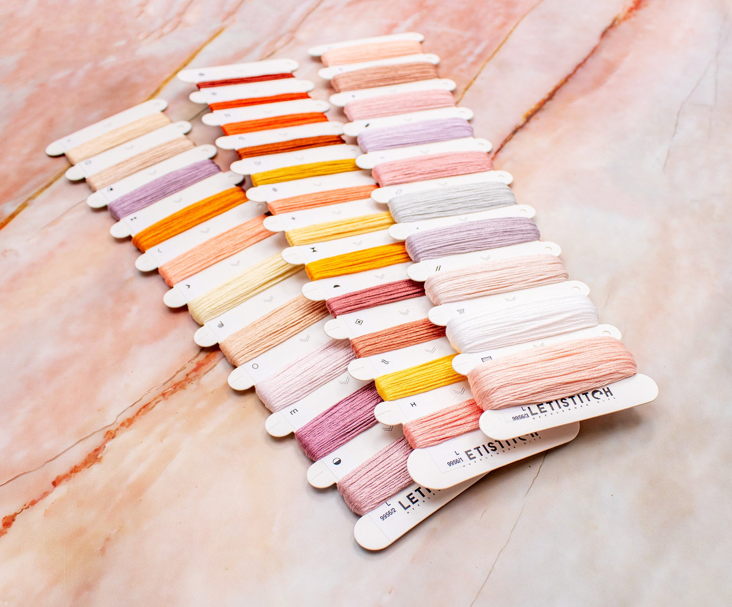 Color swatch card with pastel shades on a marble surface