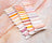 Color swatch card with pastel shades on a marble surface