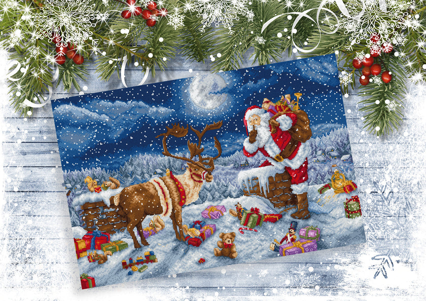 Christmas scene with Santa Claus, reindeer, and presents on a snowy landscape.