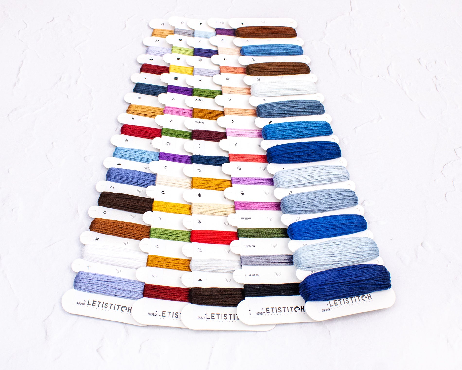 Color swatch card with embroidery floss on a white background