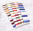 Set of colorful embroidery threads on a white background