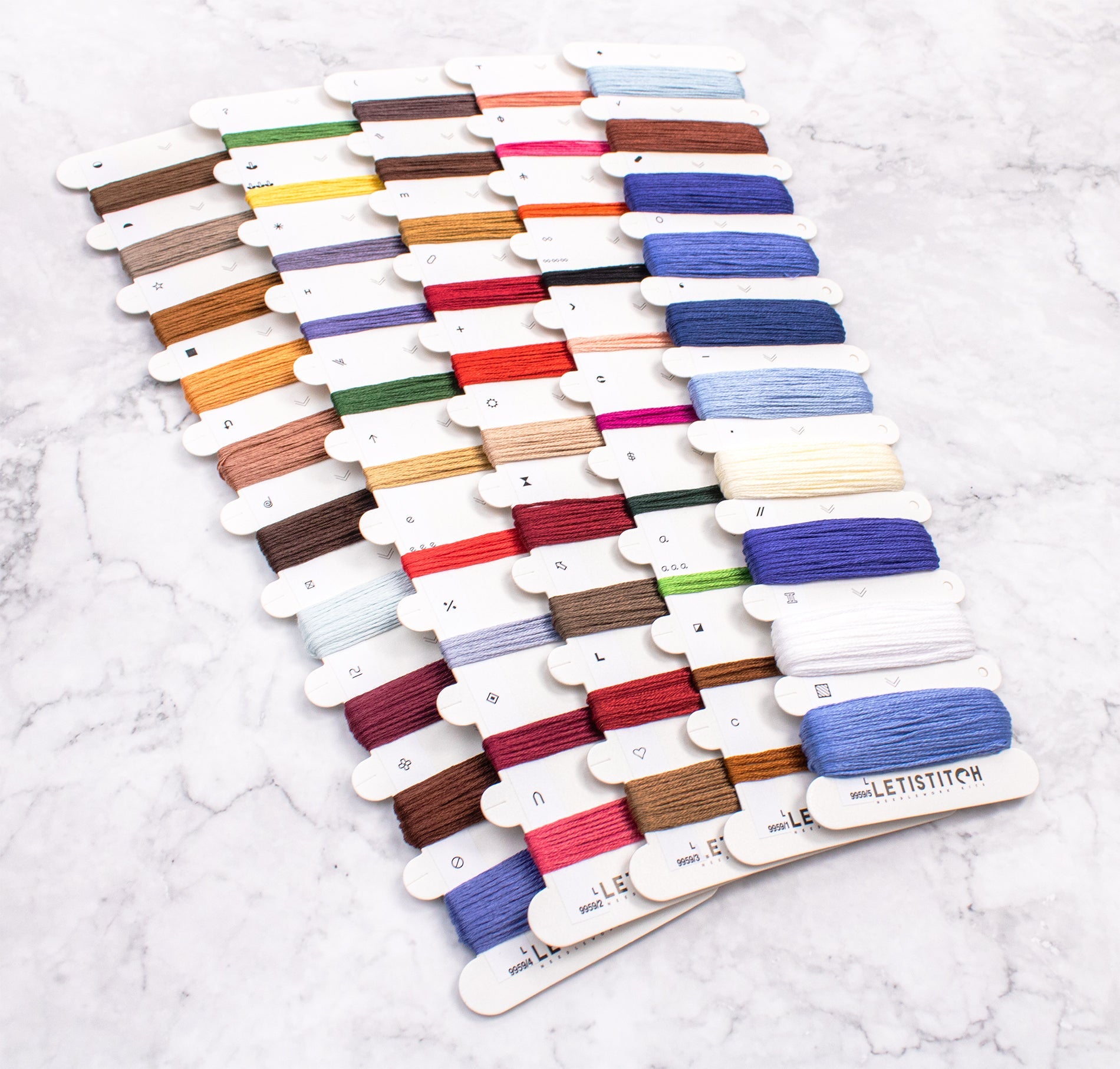 Set of colorful embroidery threads on a white background