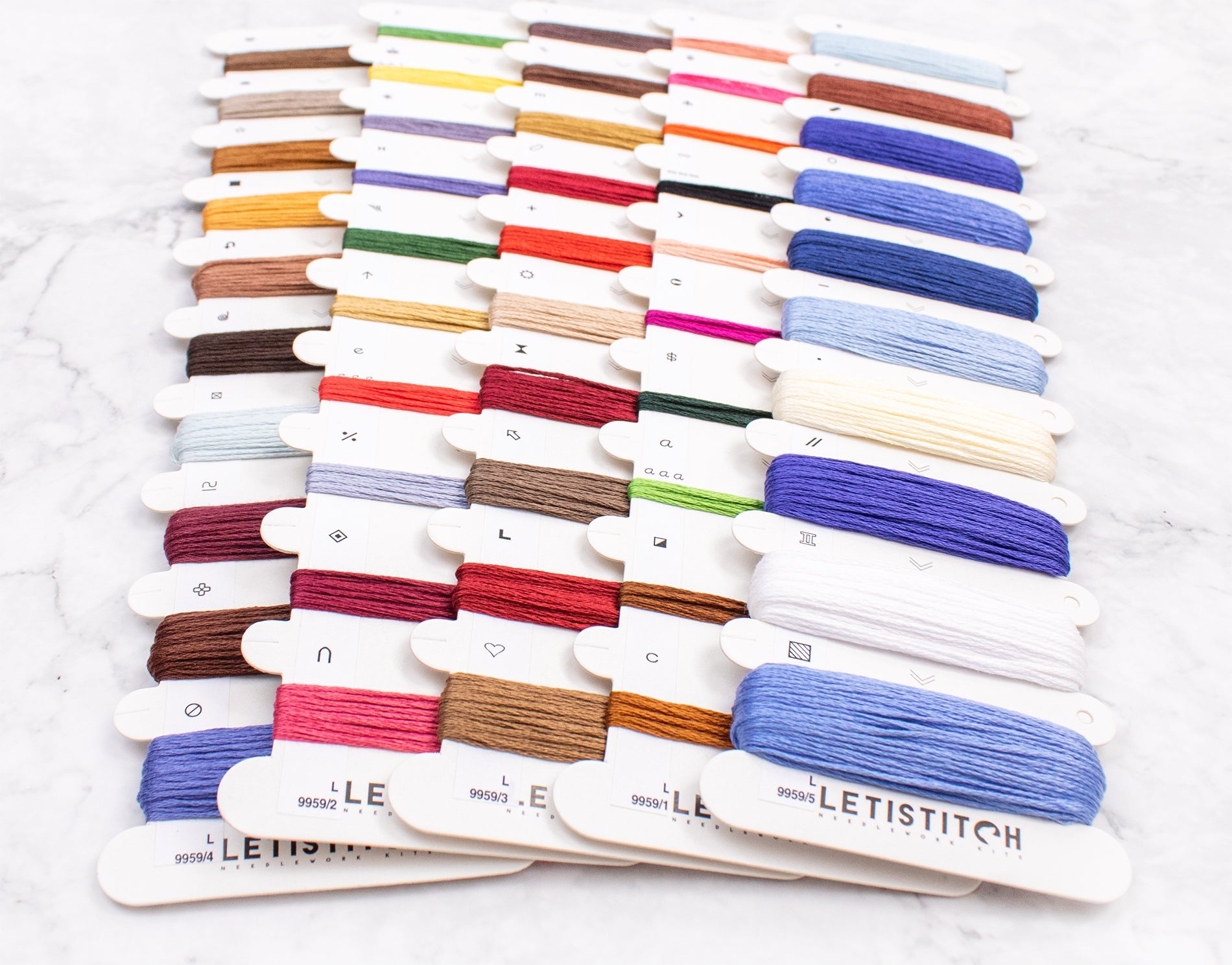 Collection of colorful embroidery threads on white cards with 'LELETISTITCH' branding.