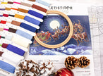Embroidery kit with thread colors, an embroidery hoop, and a Christmas-themed design on a white background.