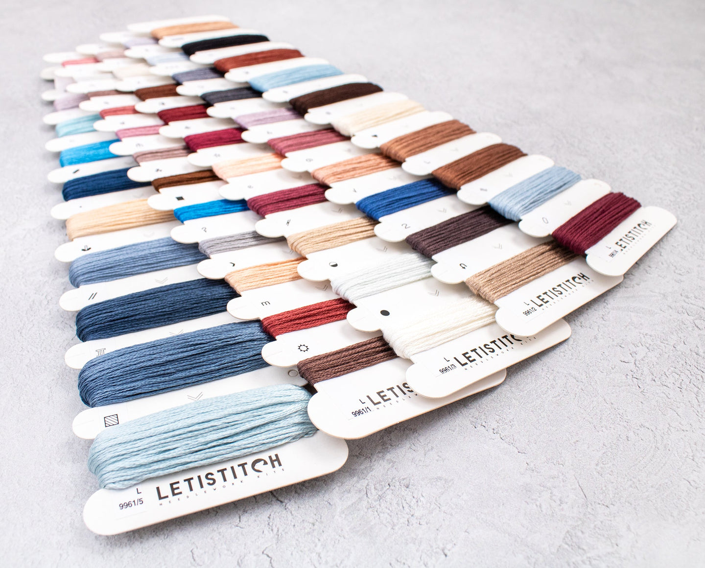 Color swatch card with various embroidery threads from LETISTITCH on a light gray background