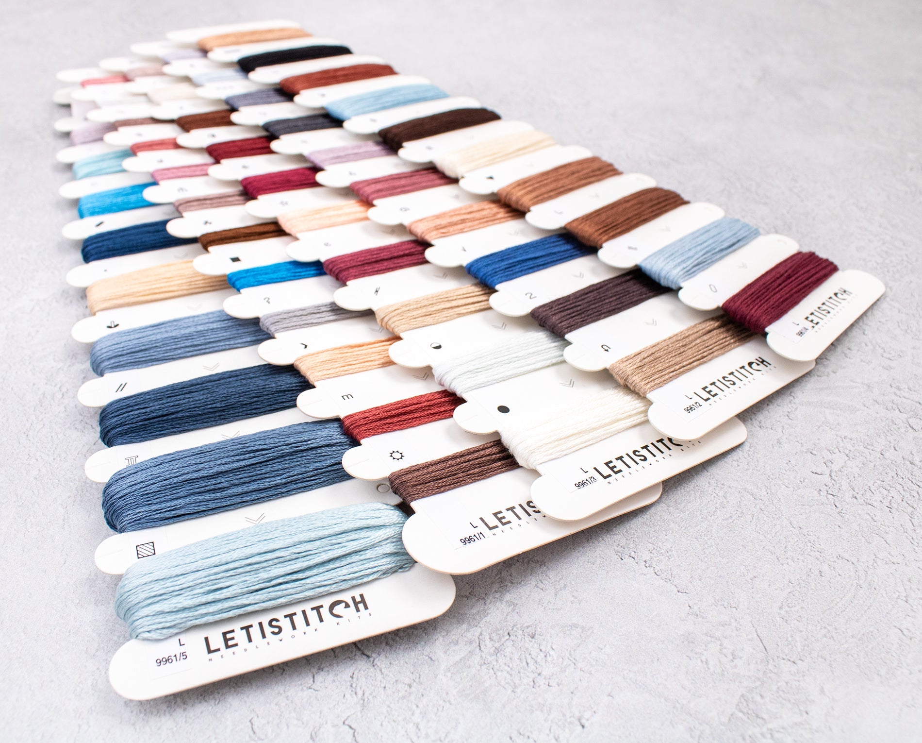 Color swatch card with various embroidery threads from LETISTITCH on a light gray background