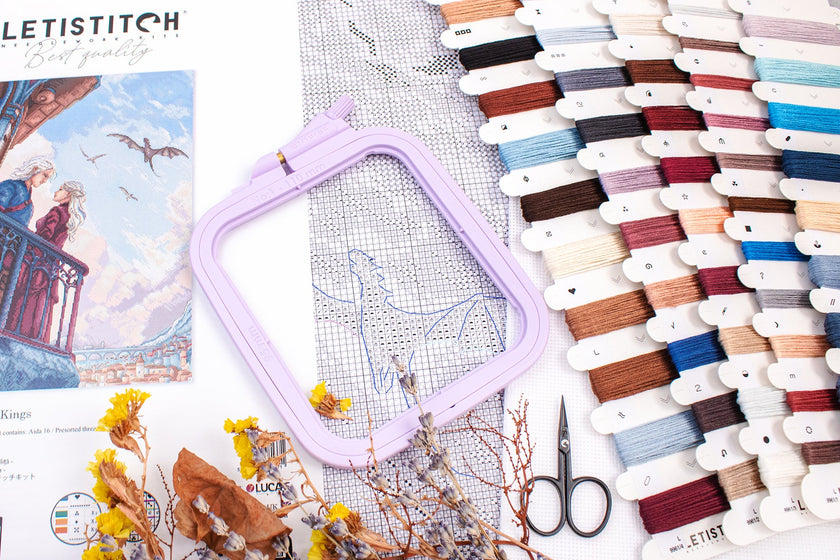 Embroidery hoop with threads and scissors on a table