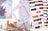 Embroidery hoop, cross-stitch pattern, scissors, and spools of thread on a surface.