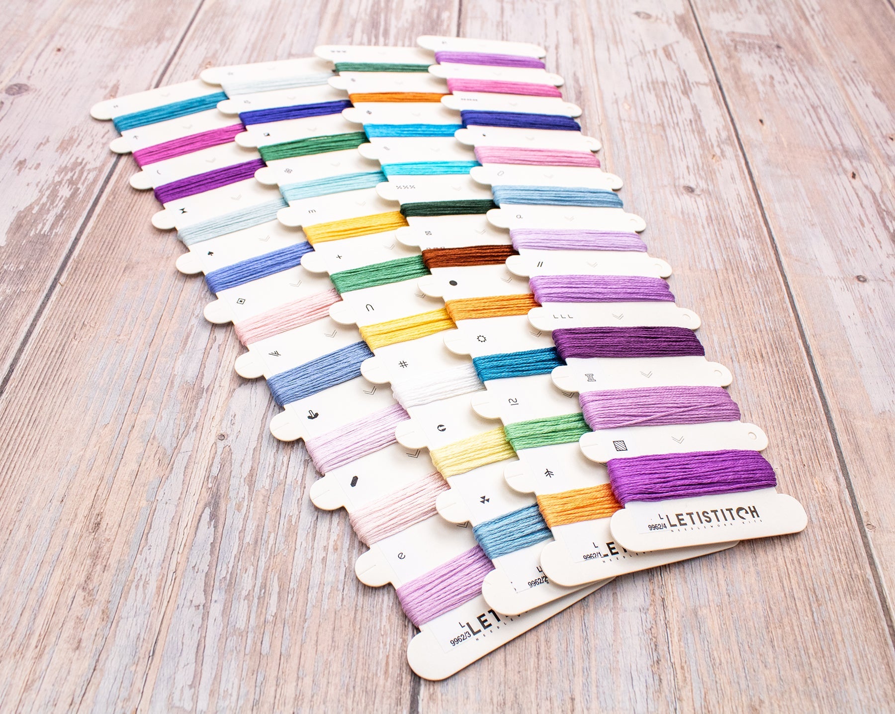 Set of colorful embroidery threads on wooden cards with 'Letistitch' branding.