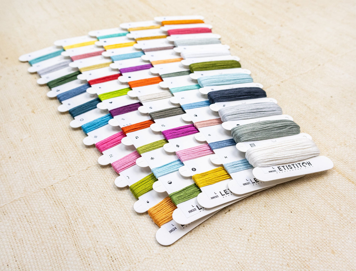 Set of colorful embroidery floss on a wooden surface