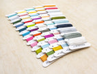 Set of colorful embroidery floss on a wooden surface