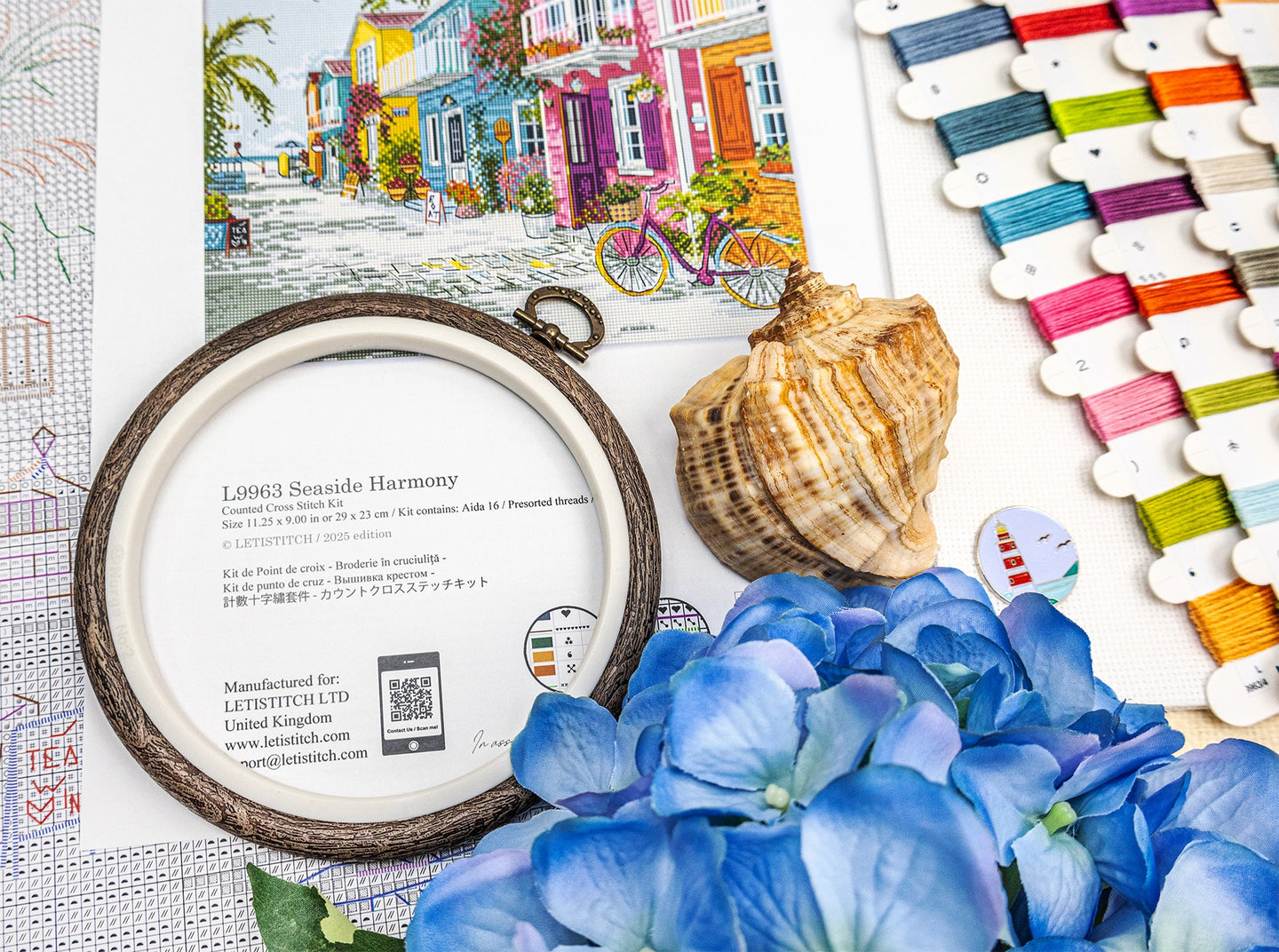 Decorative frame with floral arrangement, shell, and color swatch on a textured surface