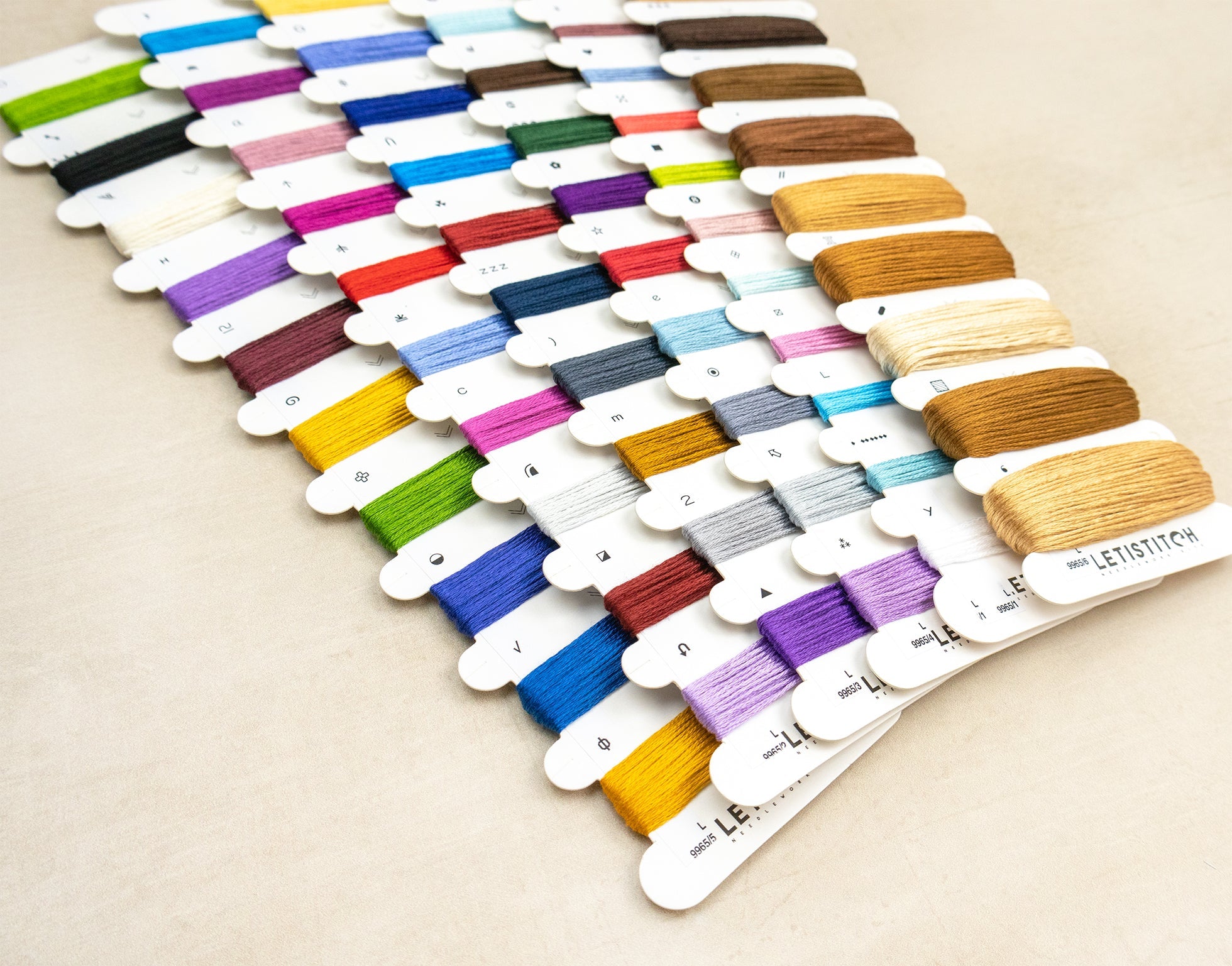 Color swatch card with various thread colors on a beige background