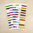 Set of colorful thread spools on a beige background